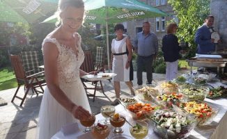 Braut bedient sich am kalten Buffet im Hof